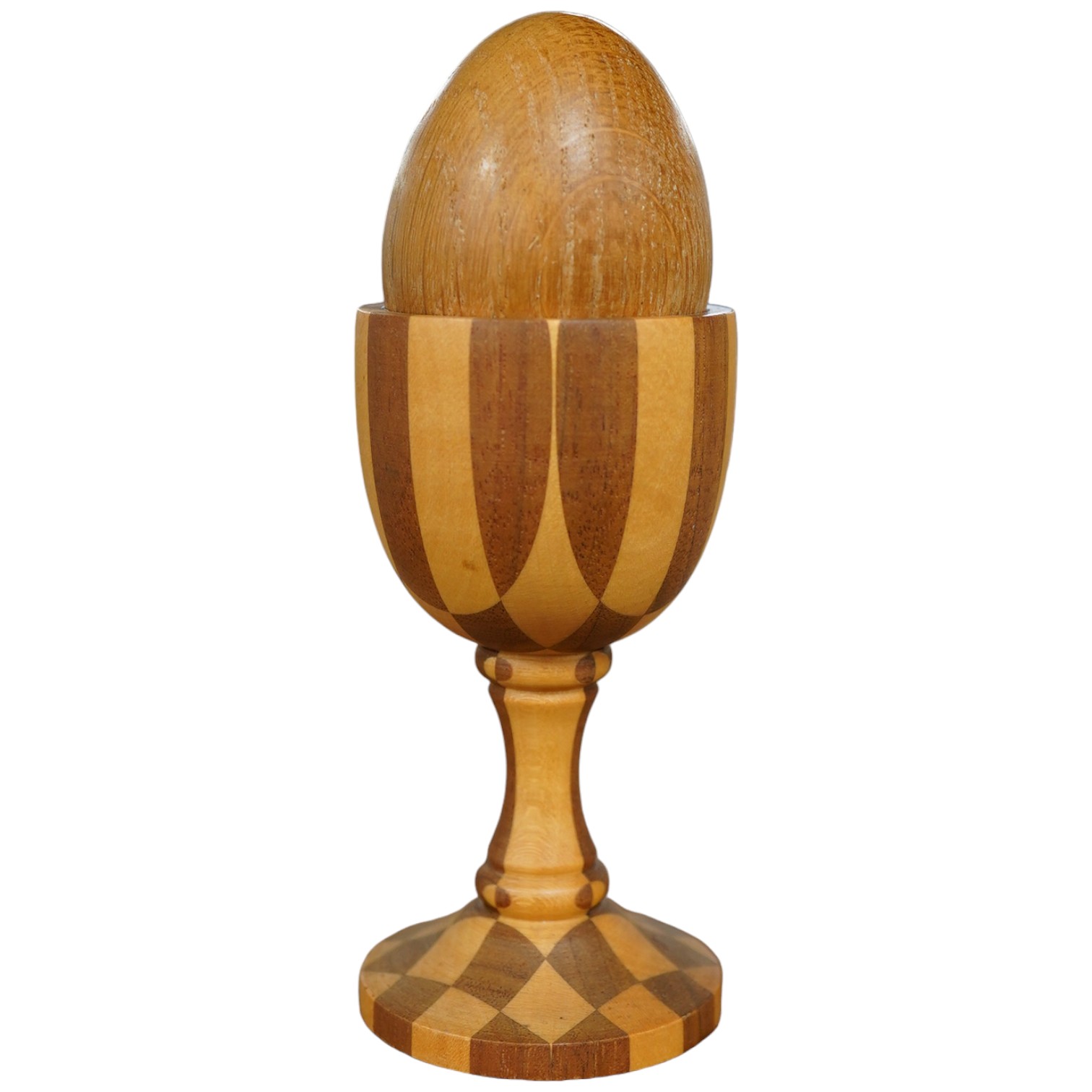 A Linley apple and holly wood egg cup with an oak egg, overall 14cm high. Condition - good